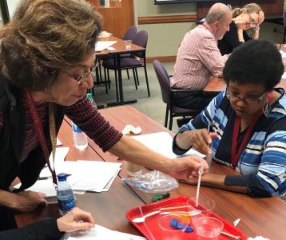 Two women participating in a science activity