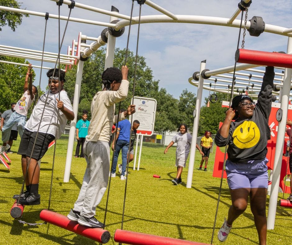 Kids at the Palmer Munroe Teen Center playing on ninja course