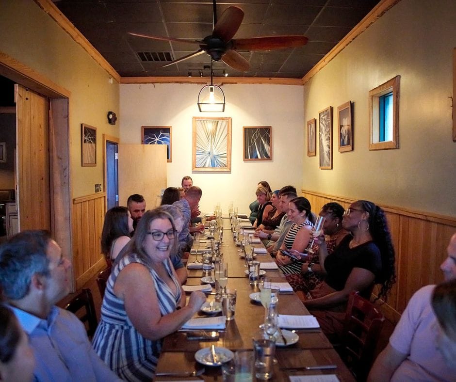 A group of people sitting at a dinner table