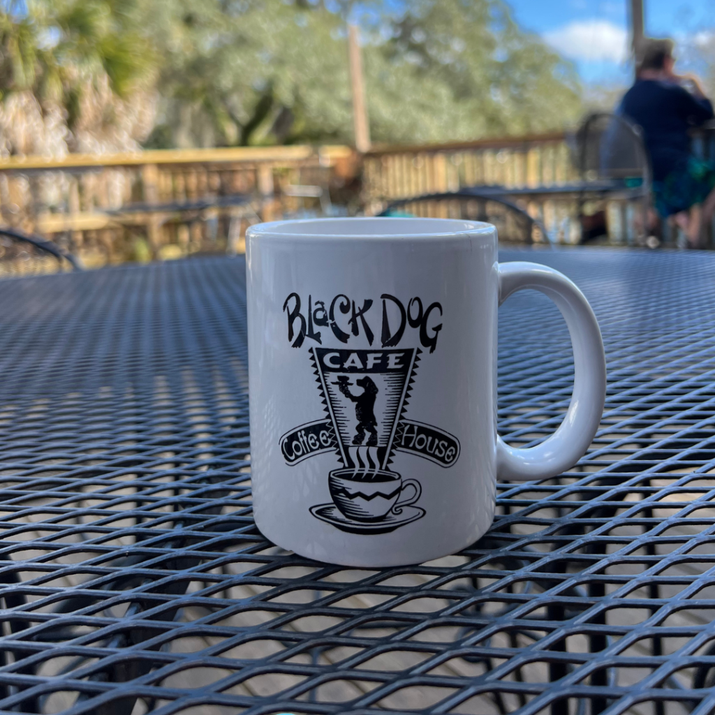 Black Dog coffee mug on table at outside patio on Lake Ella in Midtown