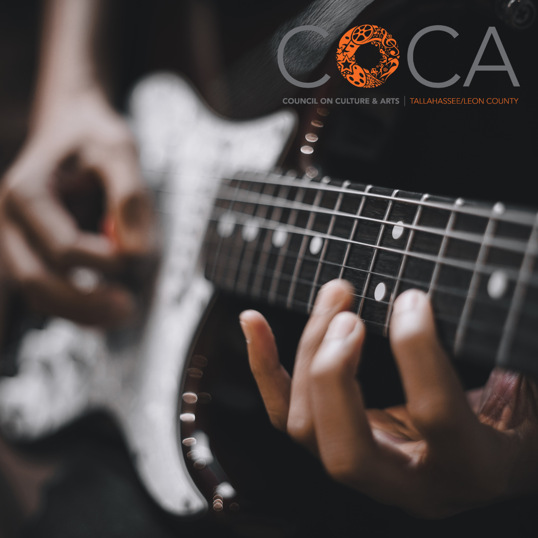 Man playing electric guitar, up close