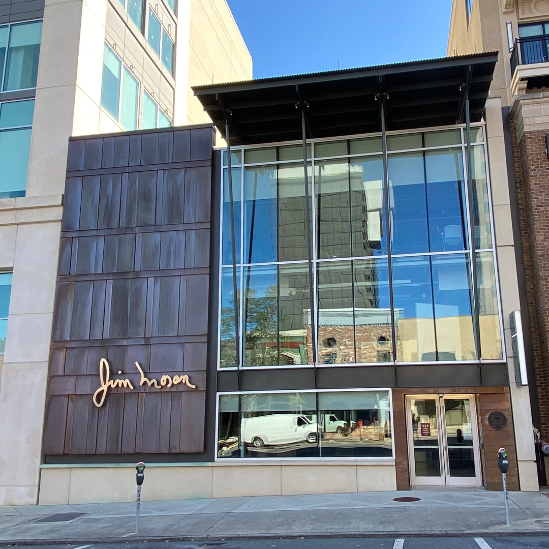 Exterior of the modern Jim Moran School of Entrepreneurship building, on a sunny day