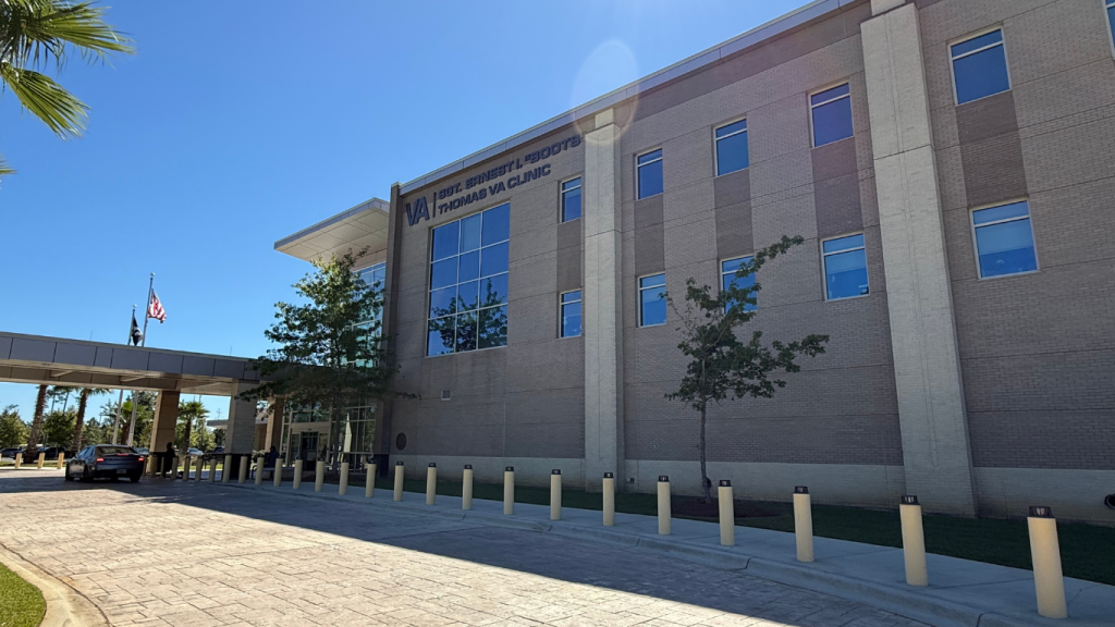 Exterior of VA Hospital in Tallahassee, Florida, with palm tree in the corner and brick pavers leading to the main entrance